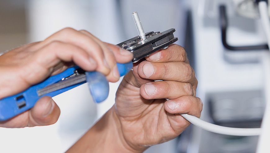 An electrician stripping a wire.