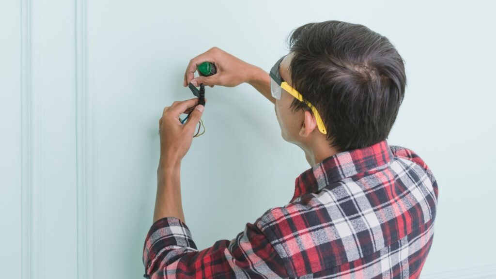 An electrician holding an electrical wires.