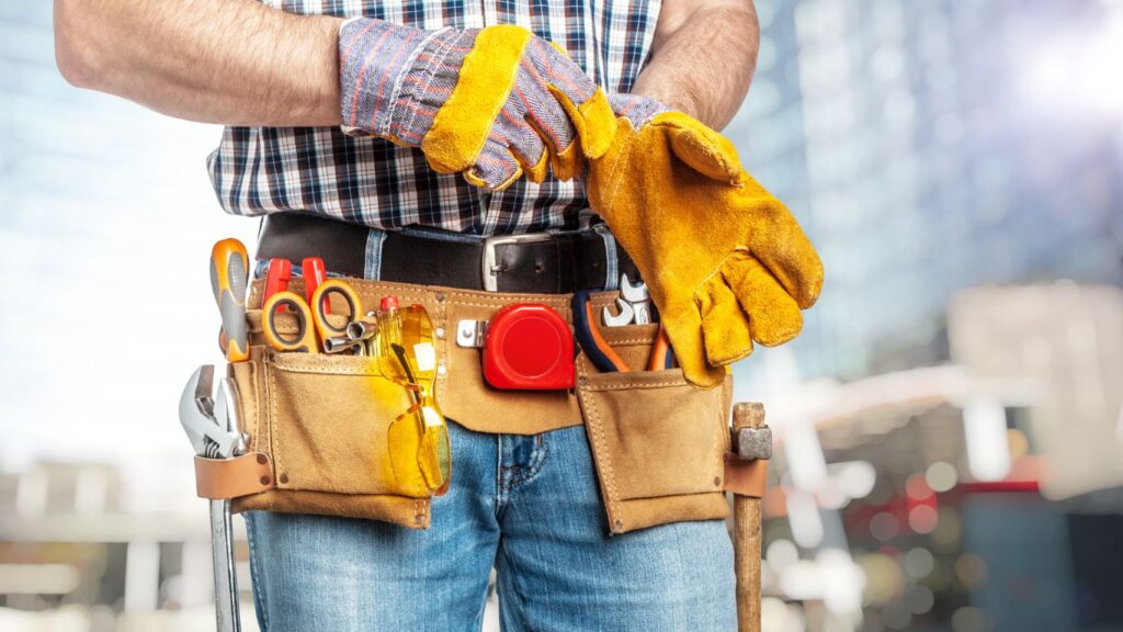 A handyman wearing gloves.